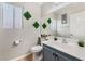 Bathroom featuring a vanity with sink, toilet, decorative wall plants, and neutral wall color at 2307 Tuscarora Ct, Las Vegas, NV 89142