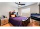 Comfortable bedroom with laminated floors, a ceiling fan, and a purple comforter at 2307 Tuscarora Ct, Las Vegas, NV 89142