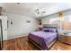 Comfortable bedroom with wood-look floors, ceiling fan, and large window at 2307 Tuscarora Ct, Las Vegas, NV 89142