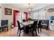 Open dining area with stylish chandelier and seating for six at 2307 Tuscarora Ct, Las Vegas, NV 89142
