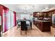 Open dining room featuring a long table and chairs, tile floors and kitchen access at 2307 Tuscarora Ct, Las Vegas, NV 89142