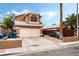 Two-story home featuring a two-car garage, driveway, a front yard, and desert landscaping at 2307 Tuscarora Ct, Las Vegas, NV 89142