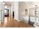 Upstairs hallway with hardwood floors, neutral paint color, and a glimpse into bedrooms and stairwell at 2307 Tuscarora Ct, Las Vegas, NV 89142