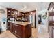 Bright kitchen features a large island with granite countertops, stainless steel appliances and wood cabinets at 2307 Tuscarora Ct, Las Vegas, NV 89142