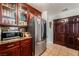 Updated kitchen showcasing stainless steel refrigerator and dark wood cabinets for ample storage space at 2307 Tuscarora Ct, Las Vegas, NV 89142