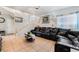 Inviting living room with tile flooring, staircase to the second floor, and comfortable black leather sofa at 2307 Tuscarora Ct, Las Vegas, NV 89142