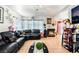 Cozy living room with tile flooring, fireplace, and spacious black leather sofa at 2307 Tuscarora Ct, Las Vegas, NV 89142