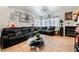 Comfortable living room with tile flooring, fireplace, and spacious black leather sofa at 2307 Tuscarora Ct, Las Vegas, NV 89142