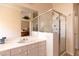 Bright bathroom featuring a glass shower, white cabinetry, a vanity, and neutral walls at 2383 Thayer Ave, Henderson, NV 89074