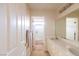Bright bathroom featuring a double vanity, neutral color palette, and access to a shower-tub combo at 2383 Thayer Ave, Henderson, NV 89074