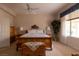 Spacious bedroom featuring a ceiling fan, neutral walls, natural lighting, and beautiful decor at 2383 Thayer Ave, Henderson, NV 89074