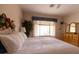 Cozy bedroom featuring a decorative dresser, charming accents, and a comfortable bed with white bedding at 2383 Thayer Ave, Henderson, NV 89074