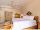 A comfortable bedroom with carpet, ceiling fan, large bed, and closet access at 2383 Thayer Ave, Henderson, NV 89074