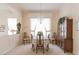 An elegant dining room with carpet, chandelier, wooden furniture, and plenty of natural light at 2383 Thayer Ave, Henderson, NV 89074