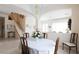 A dining room featuring table, chairs, and chandelier with access to multiple rooms and staircase at 2383 Thayer Ave, Henderson, NV 89074