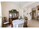 A dining room featuring carpet, wooden furniture, chandelier, and open access to other rooms at 2383 Thayer Ave, Henderson, NV 89074