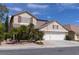Charming two-story home showcasing a well-maintained yard, mature palms, and a spacious three-car garage at 2383 Thayer Ave, Henderson, NV 89074