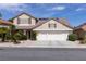 Charming two-story home with a well-manicured front yard and a two-car garage in a residential neighborhood at 2383 Thayer Ave, Henderson, NV 89074