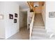 Welcoming foyer with a carpeted staircase, tiled flooring, and decorative wall art at 2383 Thayer Ave, Henderson, NV 89074