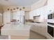 Bright kitchen with white cabinetry, stainless steel appliances, and a center island with a sink at 2383 Thayer Ave, Henderson, NV 89074
