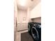 Efficient laundry room with modern washer and dryer, storage cabinets, and a convenient sink area at 2383 Thayer Ave, Henderson, NV 89074