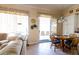 Cozy living room with a comfortable couch, a dining table, and a sliding glass door leading to the patio at 2383 Thayer Ave, Henderson, NV 89074