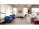 A well-decorated living room featuring two sofas, two armchairs, carpeted flooring, and a coffee table at 2383 Thayer Ave, Henderson, NV 89074