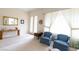 Bright living room featuring tile and carpet flooring, traditional decor, and large windows at 2383 Thayer Ave, Henderson, NV 89074