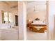 A spacious main bedroom with carpet, ceiling fan, and bathroom access at 2383 Thayer Ave, Henderson, NV 89074