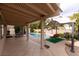 Spacious covered patio featuring tile flooring and ample seating, perfect for enjoying the backyard oasis at 2383 Thayer Ave, Henderson, NV 89074