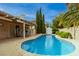 Inviting backyard pool with a covered patio, lush landscaping, and ample space for outdoor entertaining at 2383 Thayer Ave, Henderson, NV 89074