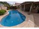 Inviting backyard pool with a covered patio, lush landscaping, and ample space for outdoor entertaining at 2383 Thayer Ave, Henderson, NV 89074