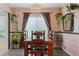 Chandelier lit dining room with wood floors and lots of plants at 2479 Domingo St, Las Vegas, NV 89121