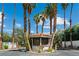 Gated community entrance featuring palm trees, desert landscaping, and a guard house for added security at 2479 Domingo St, Las Vegas, NV 89121