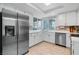 Modern kitchen with stainless steel refrigerator, white cabinets and drawers, and a tiled backsplash at 2479 Domingo St, Las Vegas, NV 89121