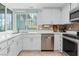Well-lit kitchen with stainless steel appliances, updated countertops, and a view to the backyard at 2479 Domingo St, Las Vegas, NV 89121