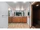 Ensuite bathroom with dual sinks, wooden cabinets, tiled floors, and steam shower at 2479 Domingo St, Las Vegas, NV 89121