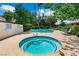 Community swimming pool and hot tub surrounded by lush greenery and palm trees in a well-maintained area at 2479 Domingo St, Las Vegas, NV 89121