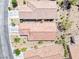 Overhead view of desert homes with terracotta roofs, gravel landscaping, and paved roads at 2501 Celestial Light Dr, Henderson, NV 89044