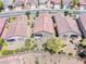 Aerial view of three homes with desert landscaping and gravel yards surrounded by sidewalks and roads at 2501 Celestial Light Dr, Henderson, NV 89044