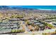 Aerial view of the Solera community featuring well-maintained homes, tennis courts, clubhouse, and mountain views at 2501 Celestial Light Dr, Henderson, NV 89044