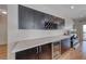 Stylish bar area with ample counter space, wine storage, and a built-in beverage cooler at 2501 Celestial Light Dr, Henderson, NV 89044