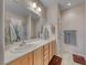 Bathroom featuring a double sink vanity with wood cabinets and a shower with a curtain at 2501 Celestial Light Dr, Henderson, NV 89044