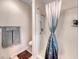 Bathroom featuring a shower with a curtain, a grey towel set, and a toilet at 2501 Celestial Light Dr, Henderson, NV 89044