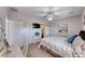 A primary bedroom featuring a ceiling fan, window with natural light and comfortable bedding at 2501 Celestial Light Dr, Henderson, NV 89044