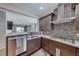 Kitchen featuring stainless steel appliances, a tile backsplash, and a breakfast bar that looks into a Gathering room at 2501 Celestial Light Dr, Henderson, NV 89044