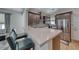 Modern kitchen featuring stainless steel appliances, a breakfast bar with chairs, and sleek countertops at 2501 Celestial Light Dr, Henderson, NV 89044
