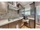 Kitchen view featuring stainless steel hood over cooktop, sleek cabinets, and under cabinet drawer at 2501 Celestial Light Dr, Henderson, NV 89044
