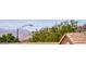 Distant Nevada mountains can be seen behind the terracotta roofs of the desert community at 2501 Celestial Light Dr, Henderson, NV 89044