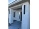 Covered home entrance with modern sconces and neutral tones at 2561 Red Rock Dr, Pahrump, NV 89048